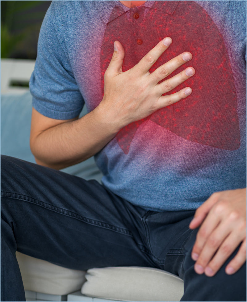 Man clutching chest with red pain highlight