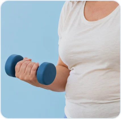 Woman holding a light dumbbell at her side