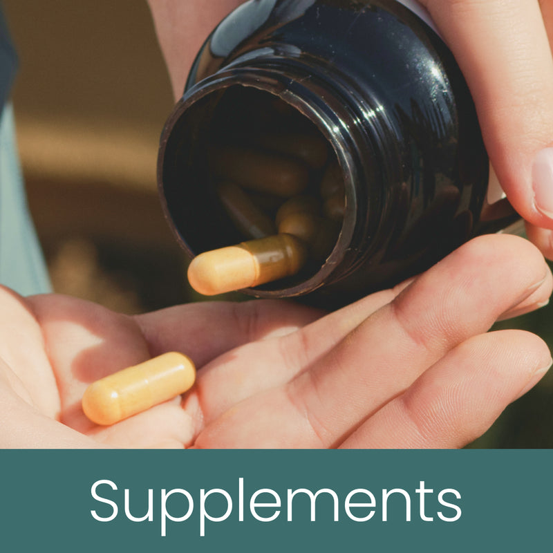 Capsules poured from supplement bottle into open hand