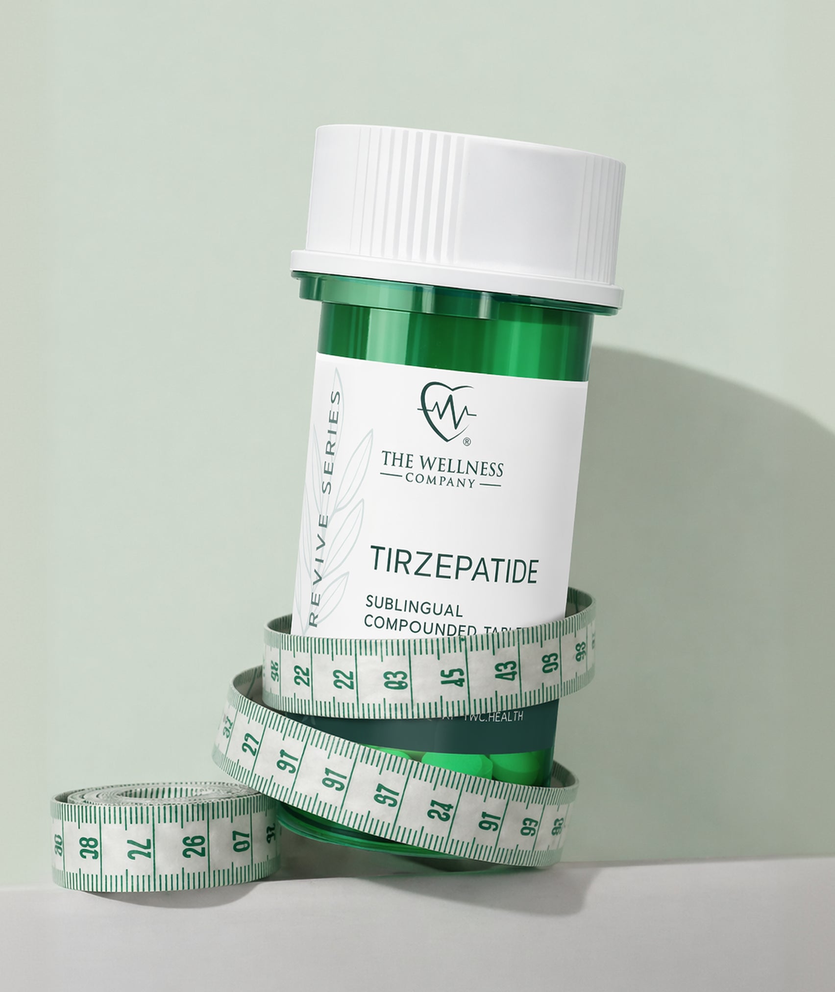 Tirzepatide sublingual tablets bottle wrapped in measuring tape